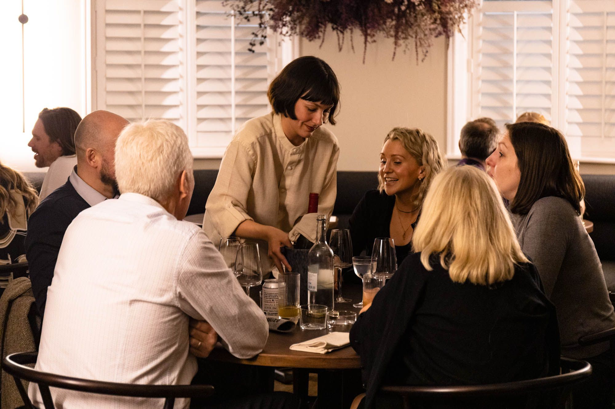 waiter serving six people at the table at dilsk