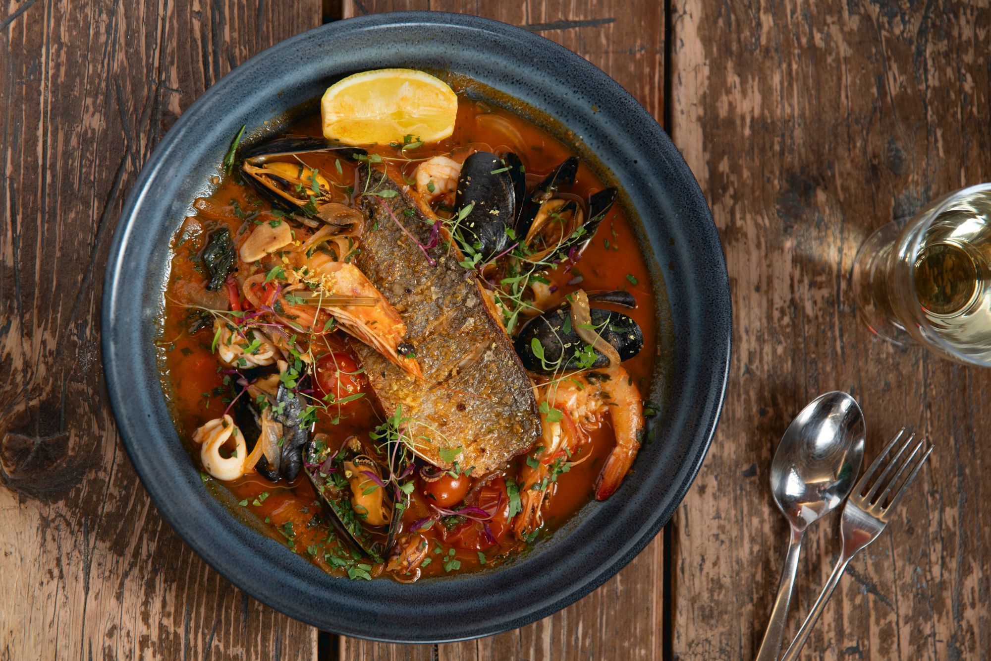 overhead shot of the seafood dish served in black pot