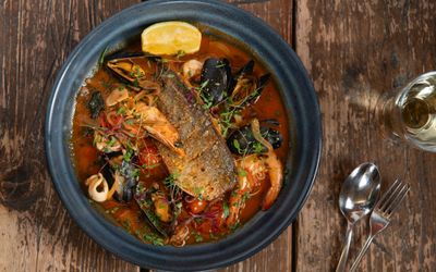 overhead shot of the seafood dish served in black pot