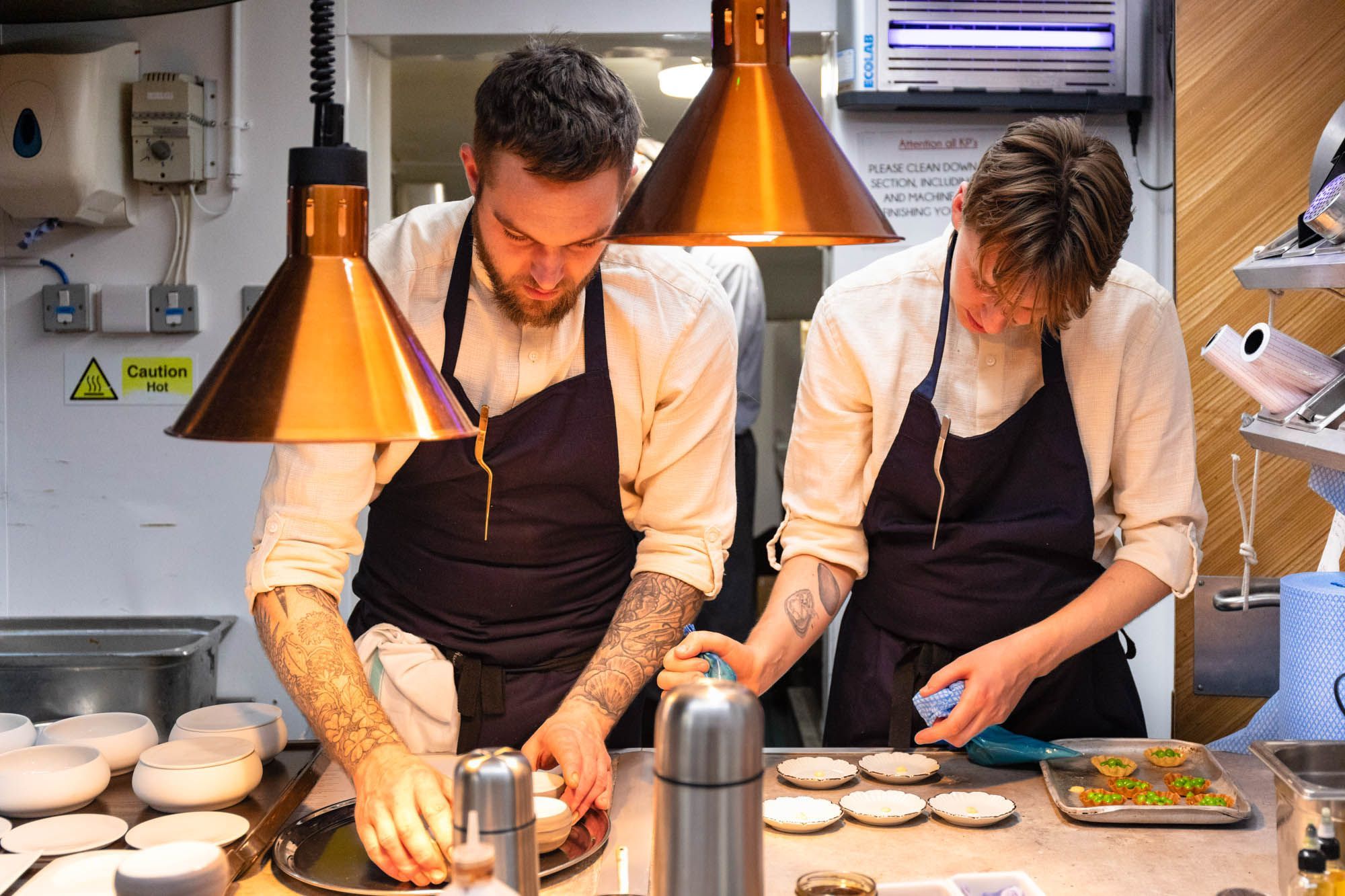 two young chefs preparing dishes at dilsk, fine dining Brighton