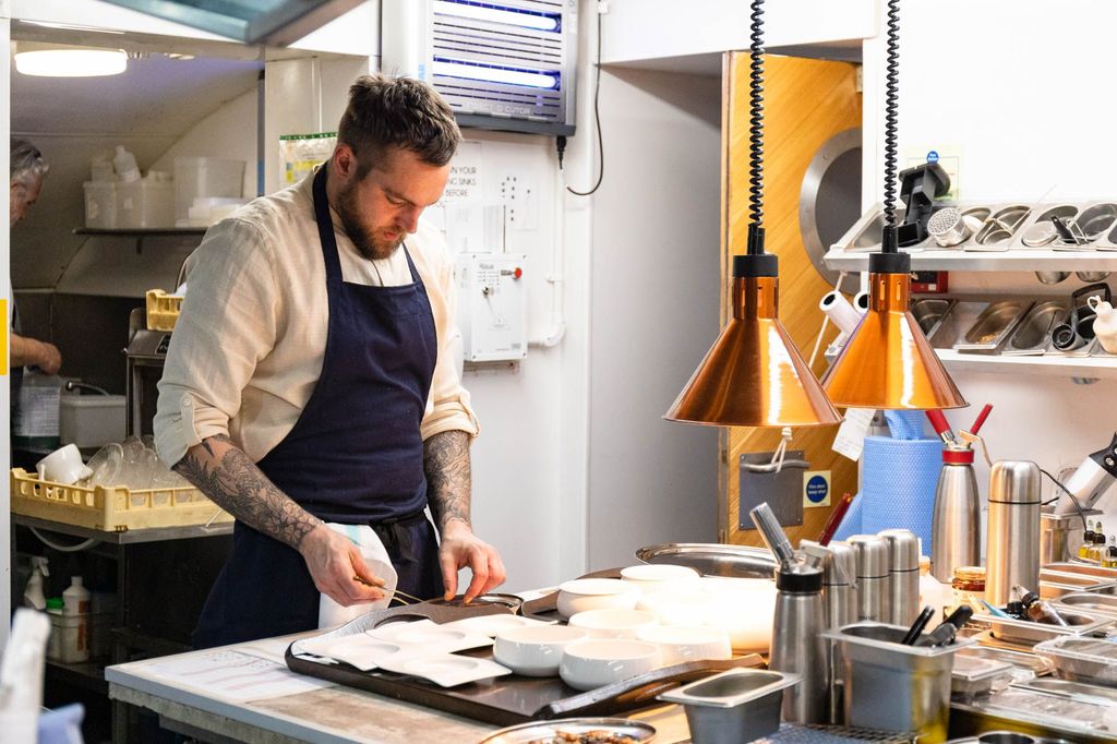 chef Tom preparing his next dish in the kitchen. Where to eat in Brighton. Dilsk