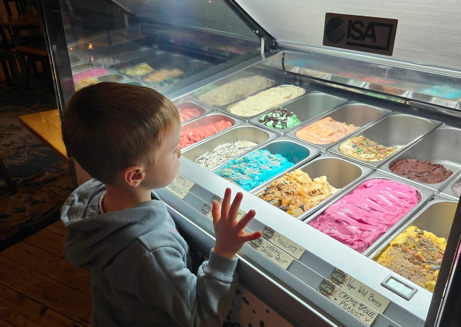 Liam looking over ice cream fridge to pick his dessert at the family dinner at The Lewes Road Inn