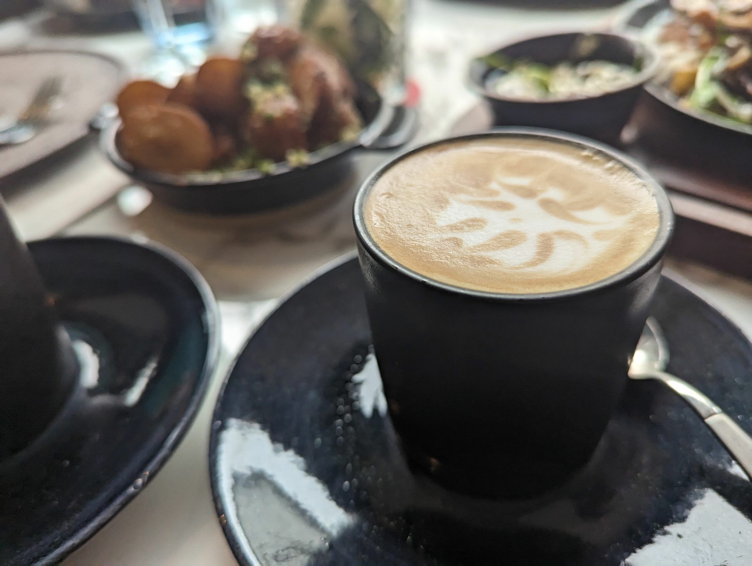 coffee served in black coffee cup. Brunch Seven Dials