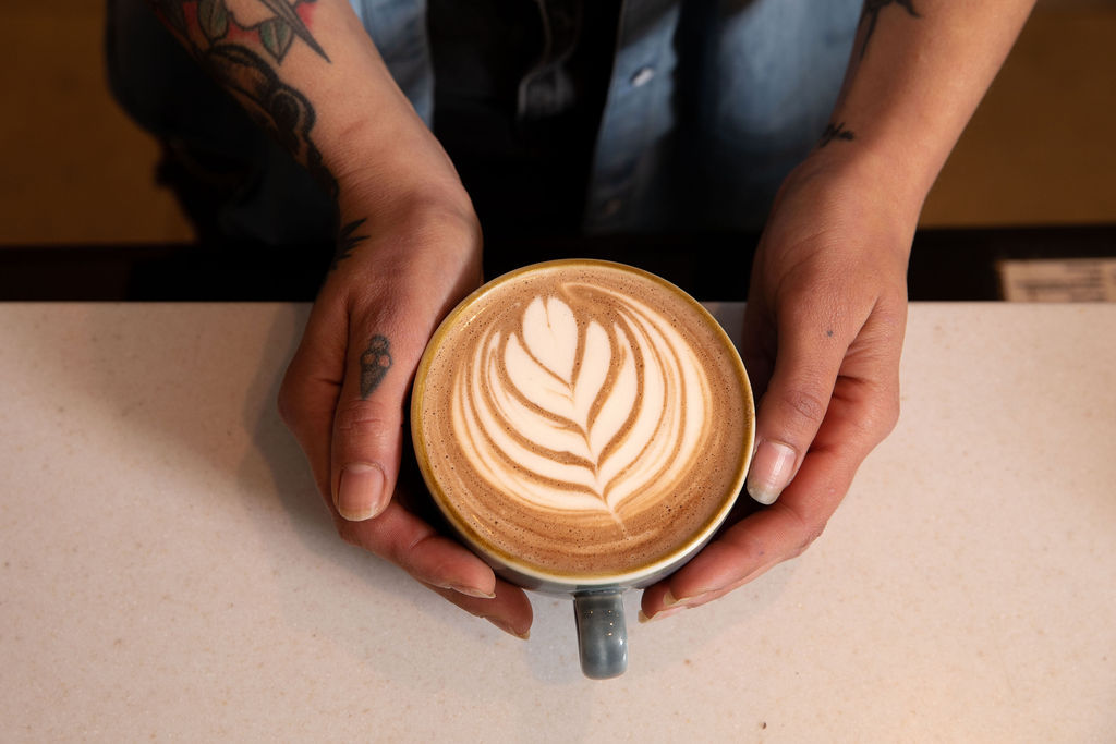over head shot of the hands holding a coffee
