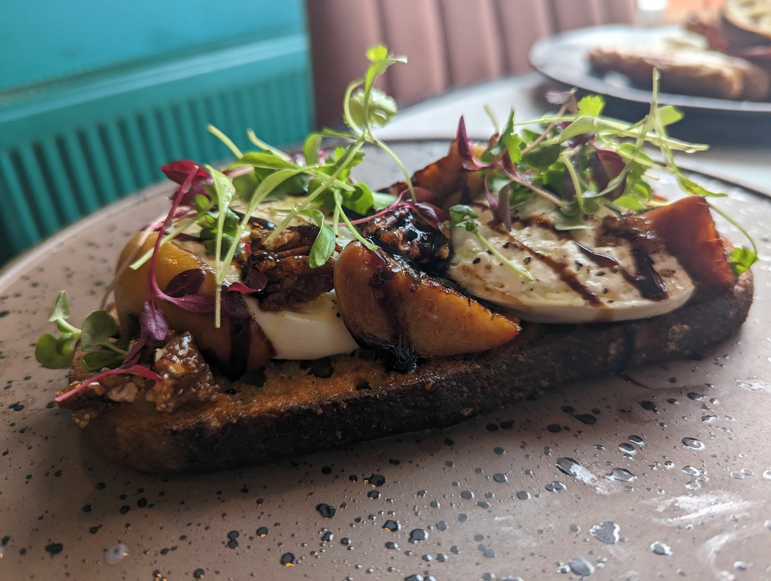  A thick slice of very good sourdough came topped with soft, cool, white Burrata, little chunks of roasted peach and walnuts. Brunch Seven Dials