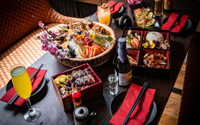 A selection of Japanese food at the restaurant Wabi Sabi, served on a dark wooden table.