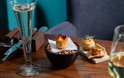 A starter dish and canapés with a flute of sparkling wine.