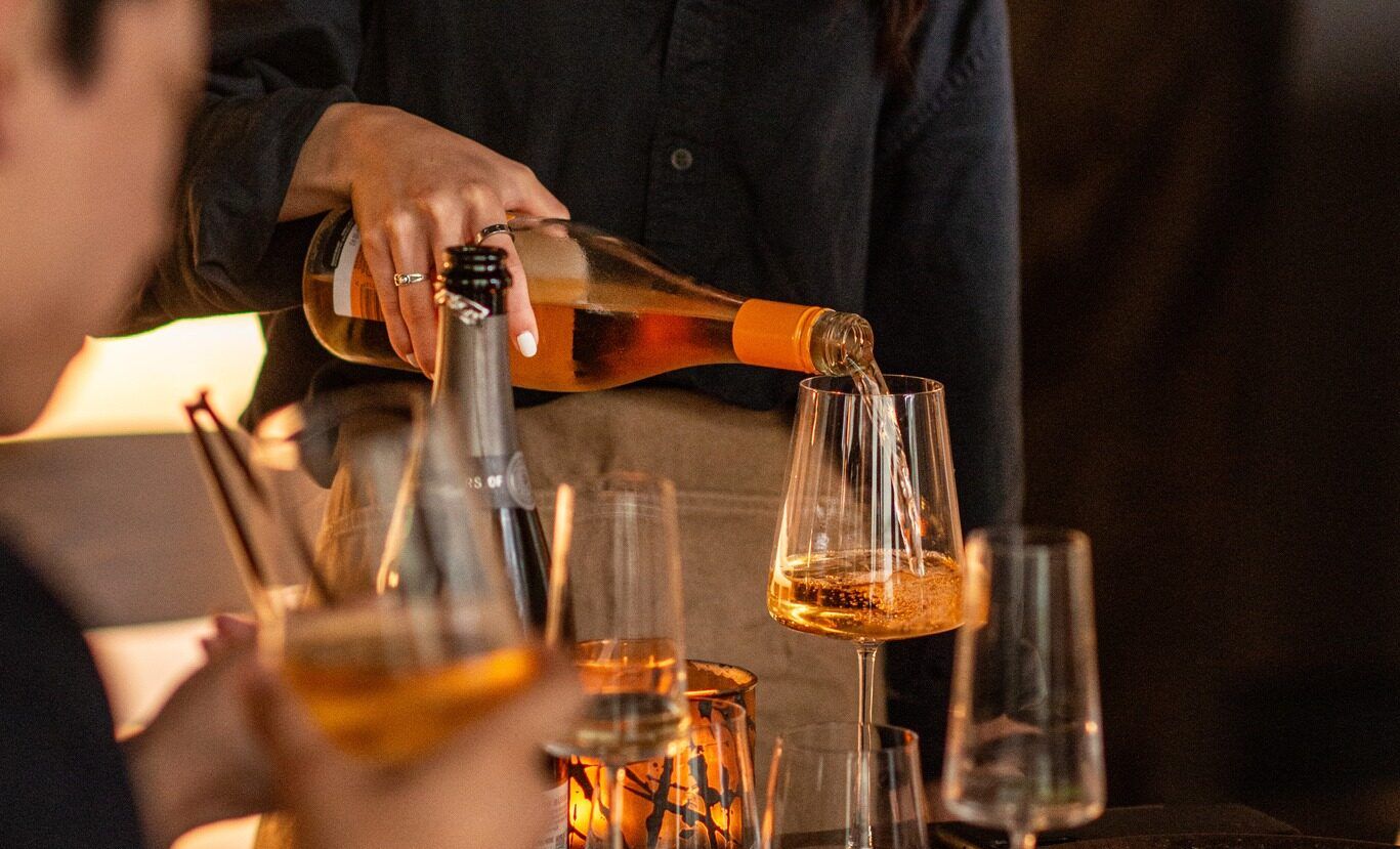 waiter sipping wine in the glass at fumi