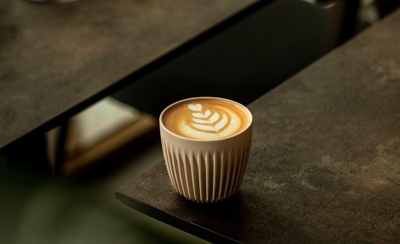 flat white coffee on the black table at FUmi