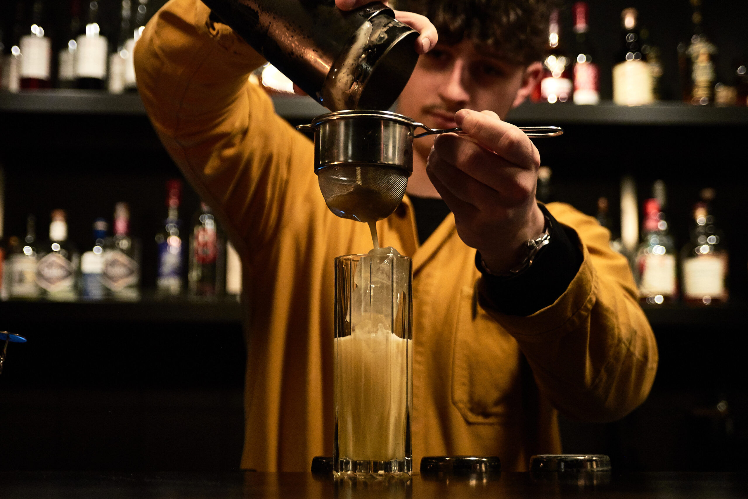 Lunch at etch. with cocktails being made by a bar tender in a yellow shirt.