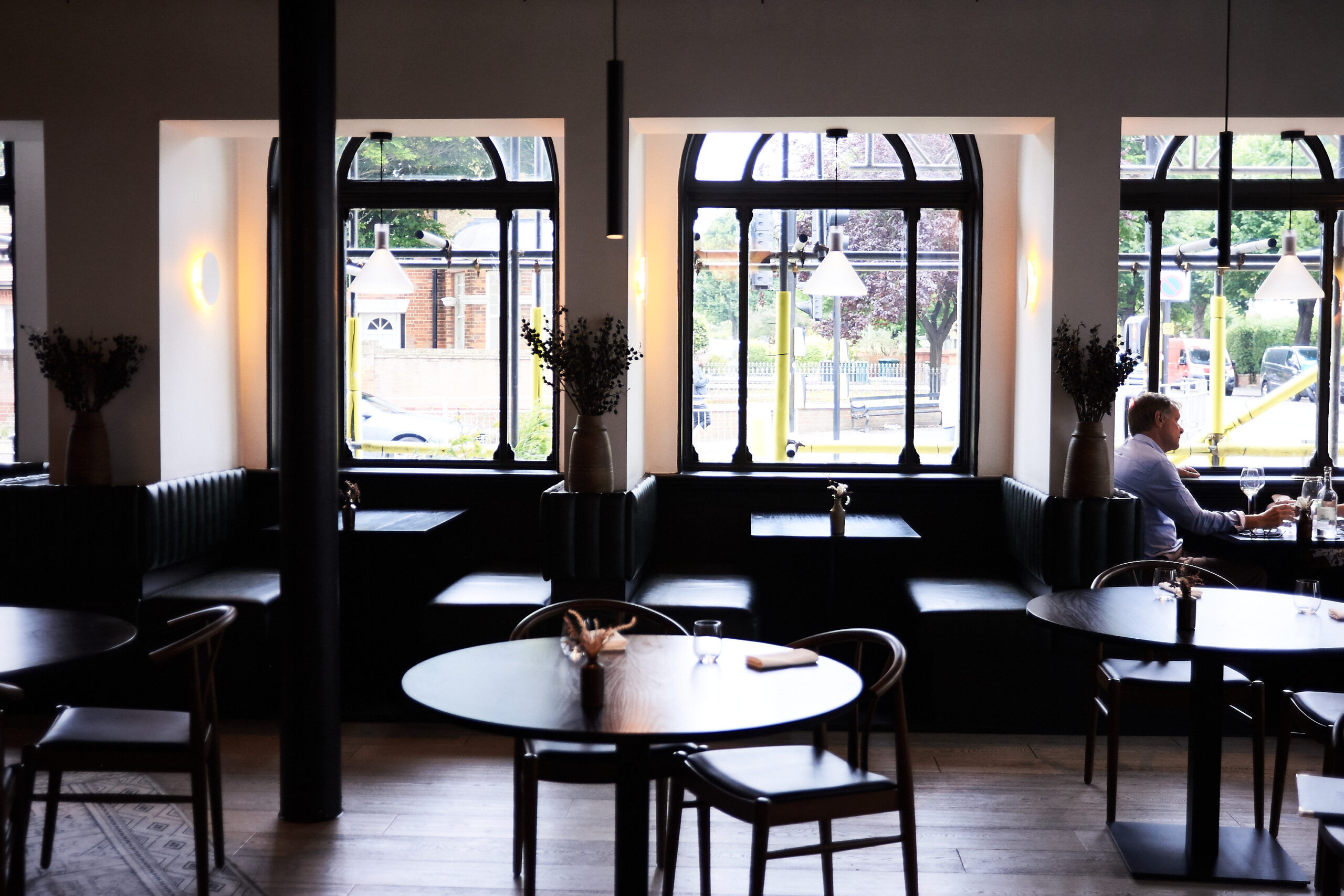 Interior photograph of etch. restaurant with large windows.