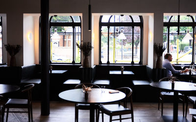 Interior photograph of etch. restaurant with large windows.