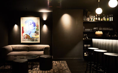 Cocktail bar at etch. restaurant, black interiors with artwork on the walls.