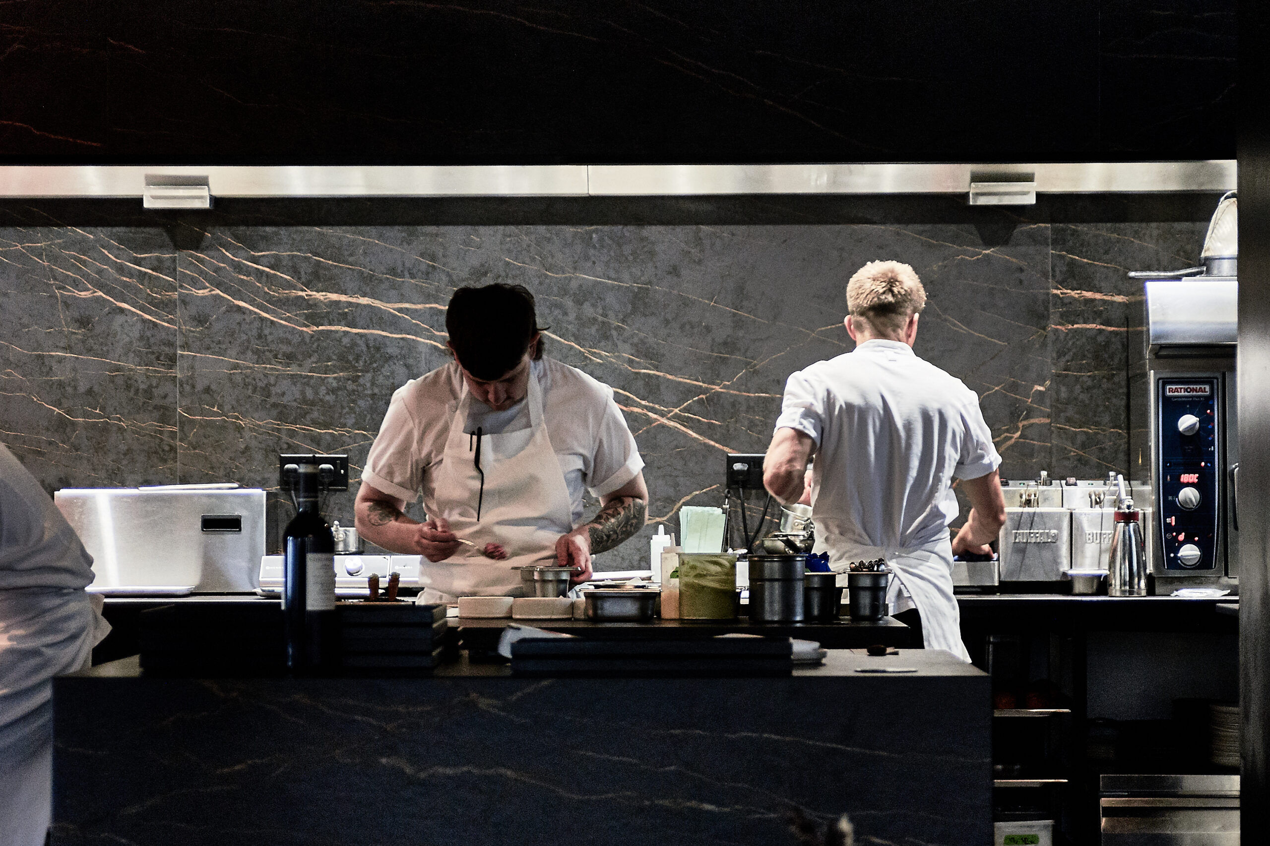 Chefs in the graphite decorated kitchen at etch. restaurant.