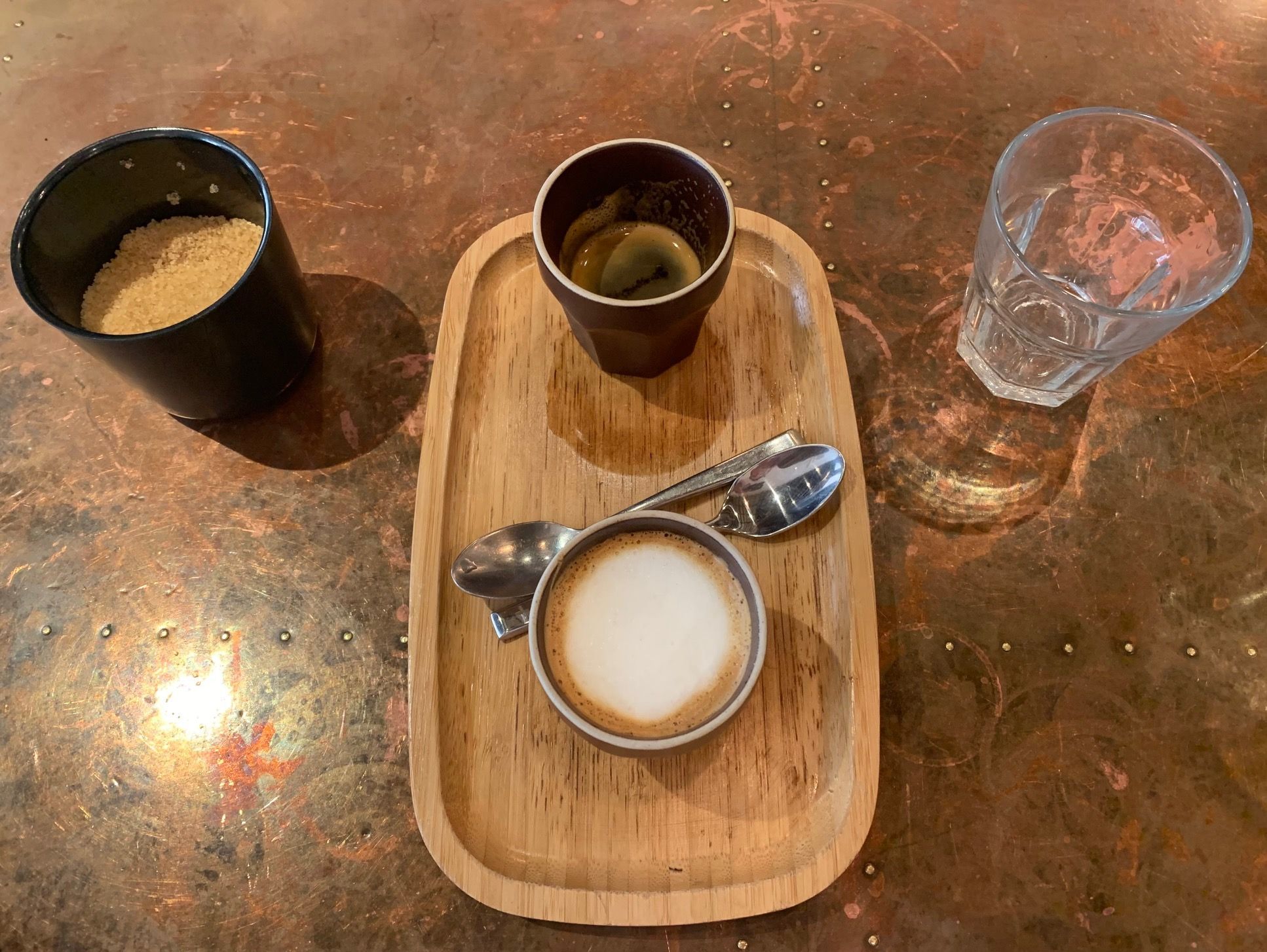 over head shot of the flat white and espresso served on wooden board at the LITL. Mediterranean treat