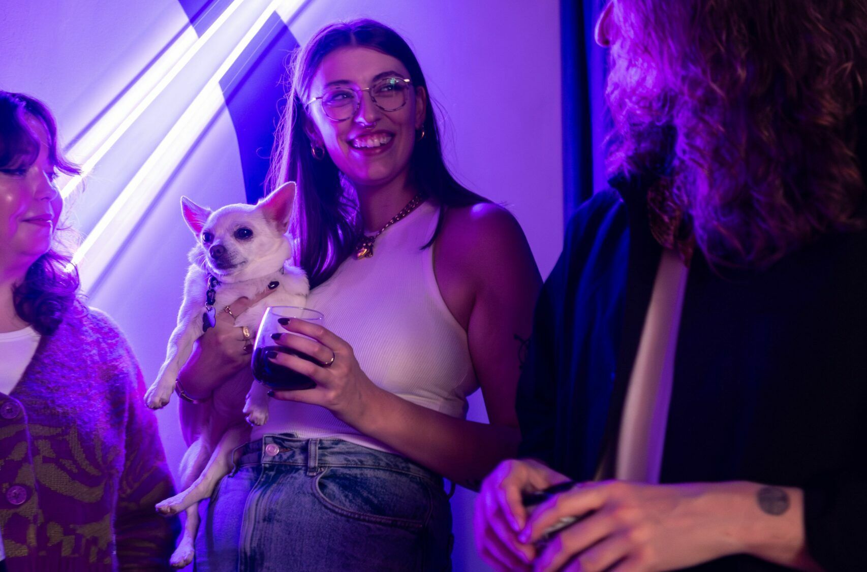 Girl holding white dog in hand at Torstigbar