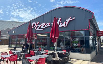 The curvy shaped roof of the Pizza Hut building on Brighton Marina. Serving fresh pizzas