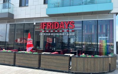 The glass facade and red signage of TGI Fridays restaurant and Bar on Brighton Marina