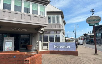 The Brighton Harvester which is situated on the Brighton Marina. A grey building with light blue branding in the foreground
