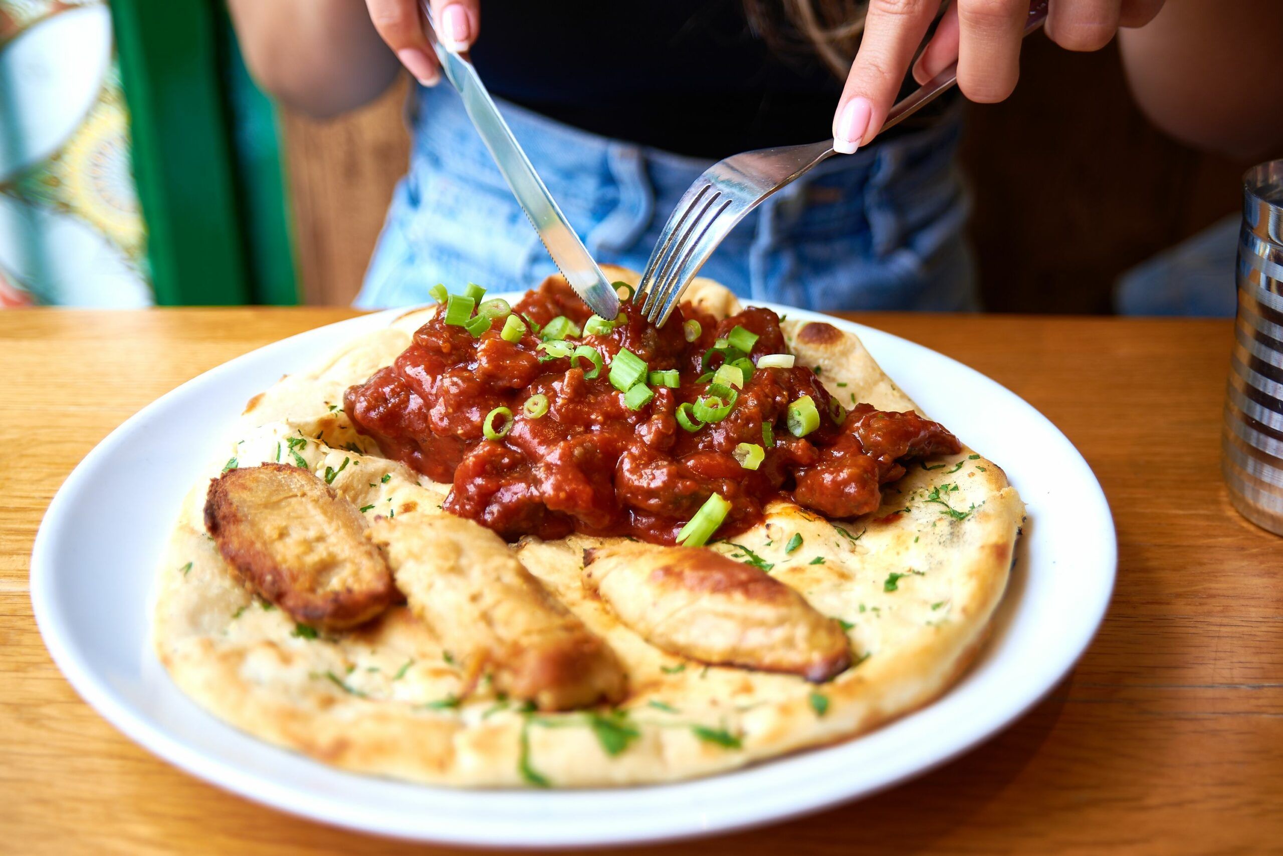 Mouthwatering new brunch menu at the Curry Leaf Cafe. Naan with vegan sausage and mushroom in the red sauce