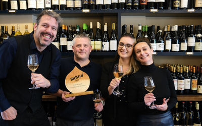 Wine Tasting Brighton. Anna, Paul and the team gearing up for one of their Brighton wine tasting events. The backdrop is a wall of wine, displaying their shop front located on Church Road in Hove. Fourth and Church also have noteworthy wine lists. Fourth and Church won the BRAVO 2023 best wine list in Brighton