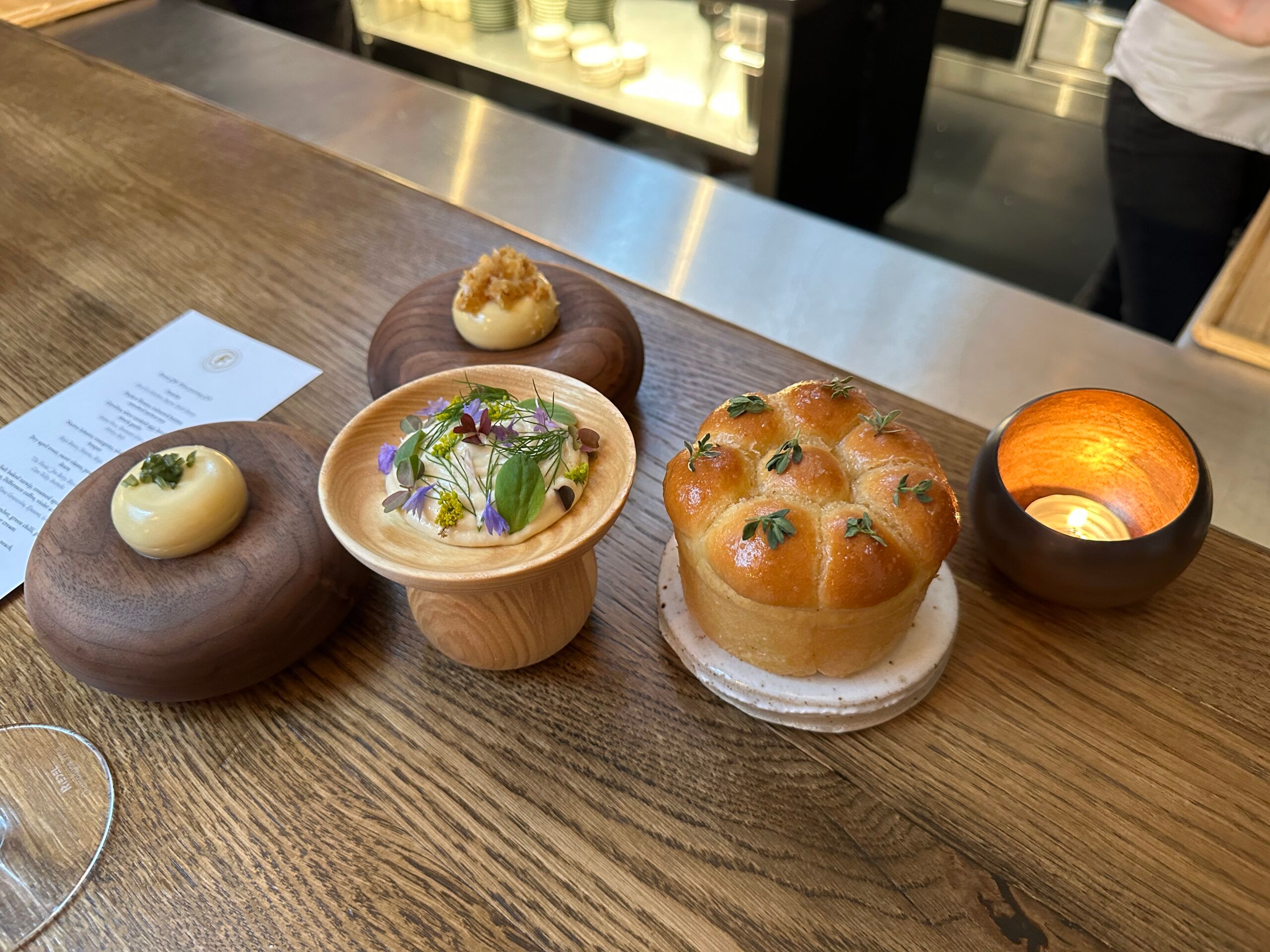 Breads and butters served on a wooden table at Furna