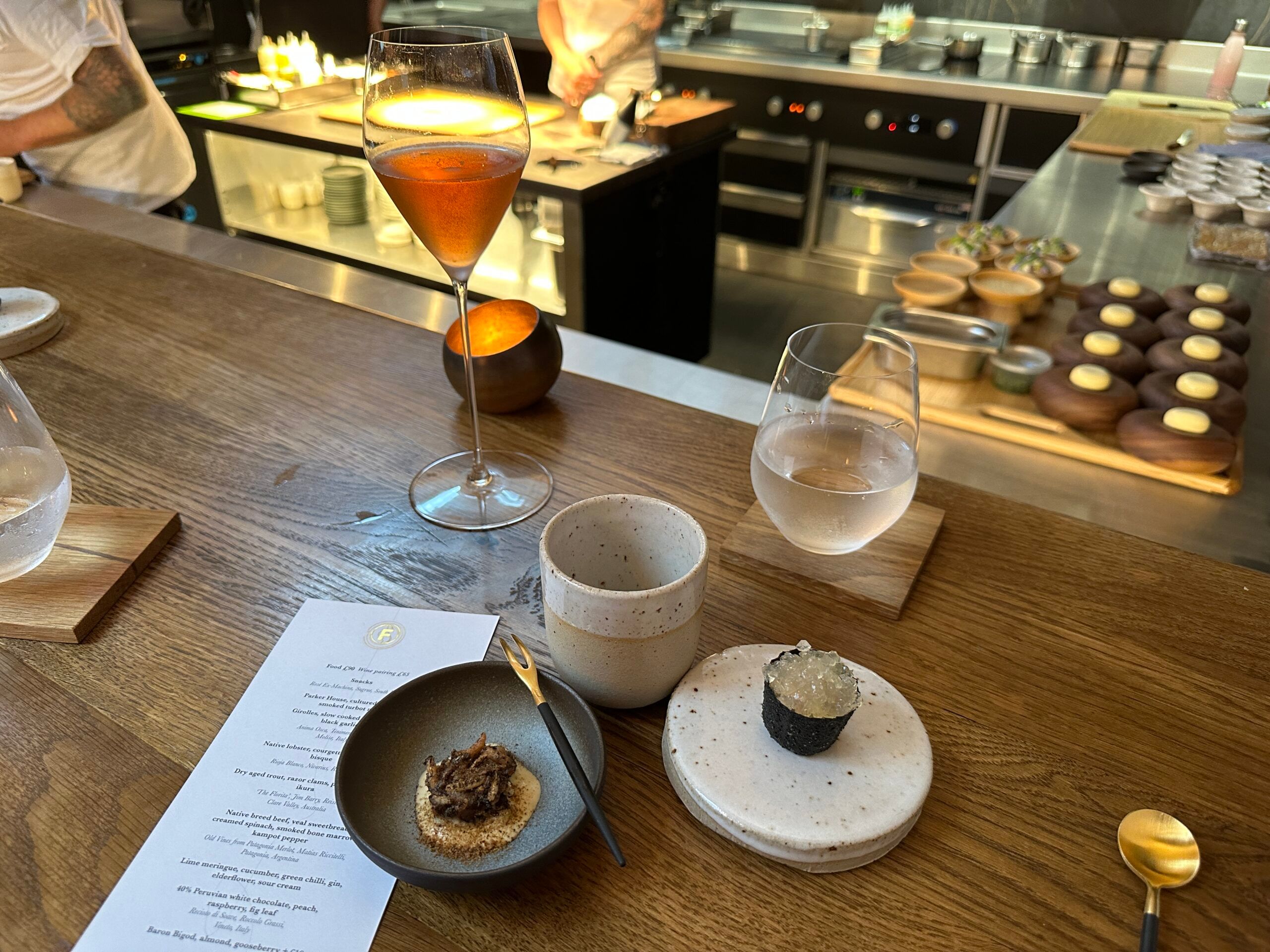 Chef Dave Mothersill's restaurant serves snacks with wine at the open kitchen.