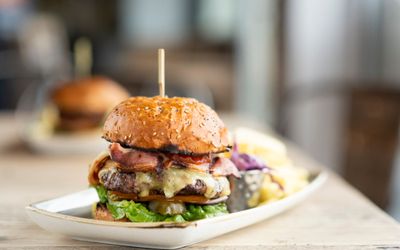 beef burger served on white plate at Ohso