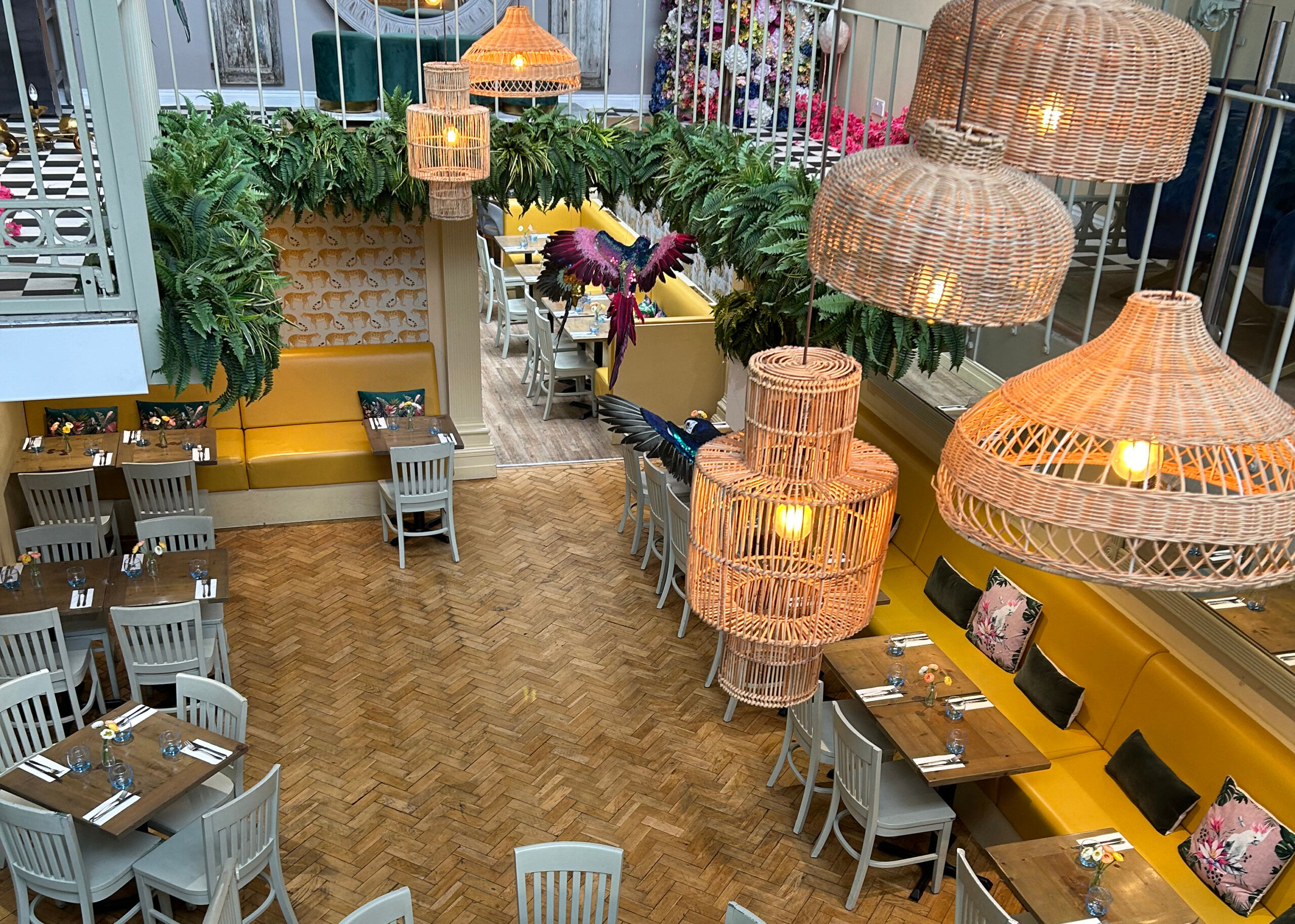 Interior of Jo and Co restaurant taken from the mezzanine with wooden floors and lampshades.