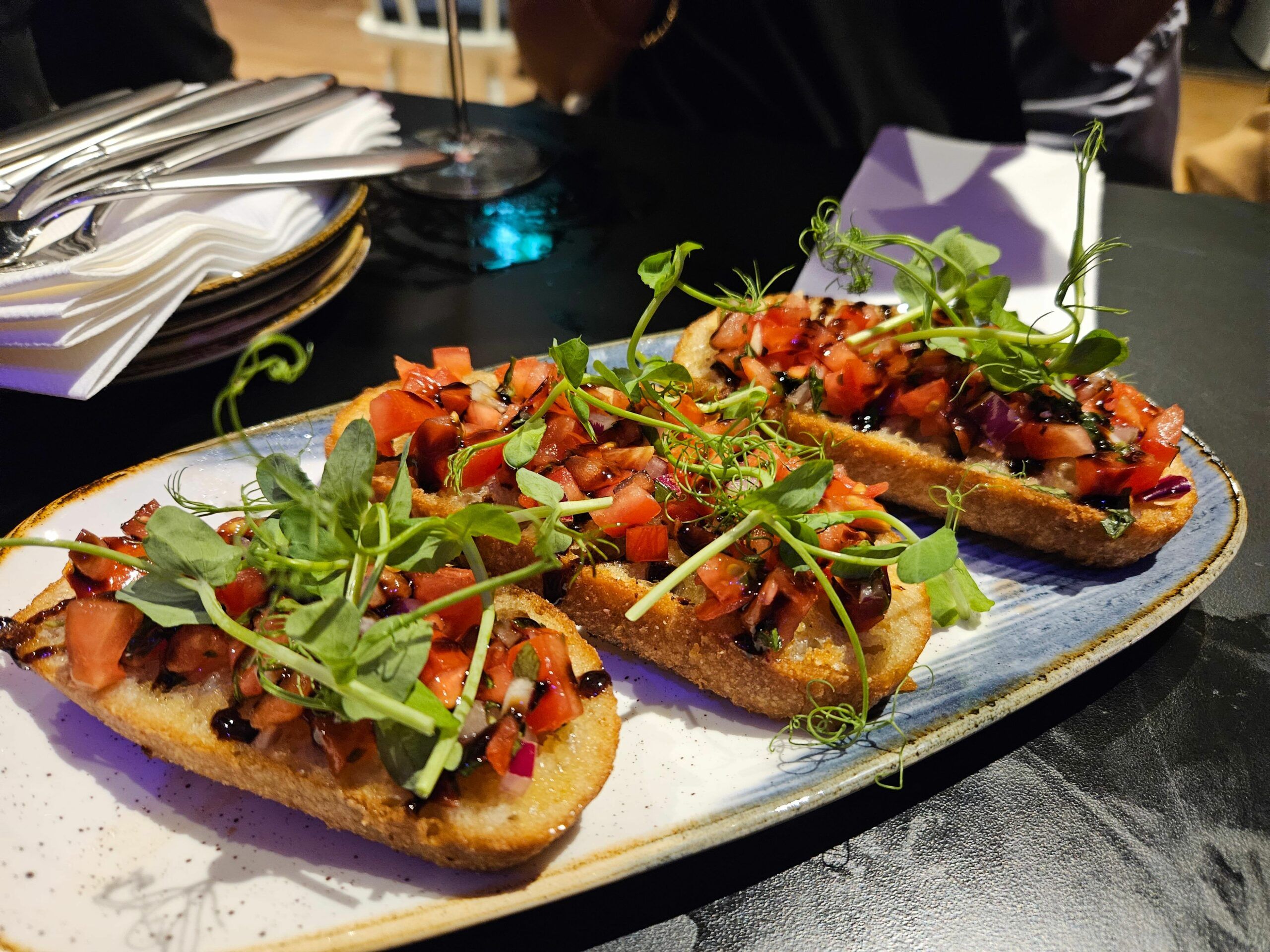 bright, fresh vegetarian bruschetta drizzled with sweet balsamic glaze. The bread was golden and crunchy with a great pile of fresh tomato topped with micro herbs