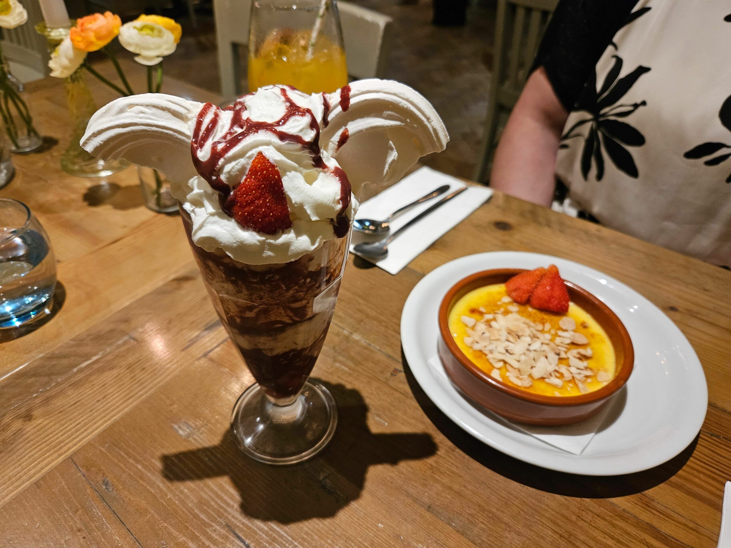 crème brûlée topped with sliced almonds and fresh strawberries and sundae glass piled high with fresh whipped cream, sliced strawberries, drizzled with raspberry sauce and filled with strawberry ice cream. Friday Night