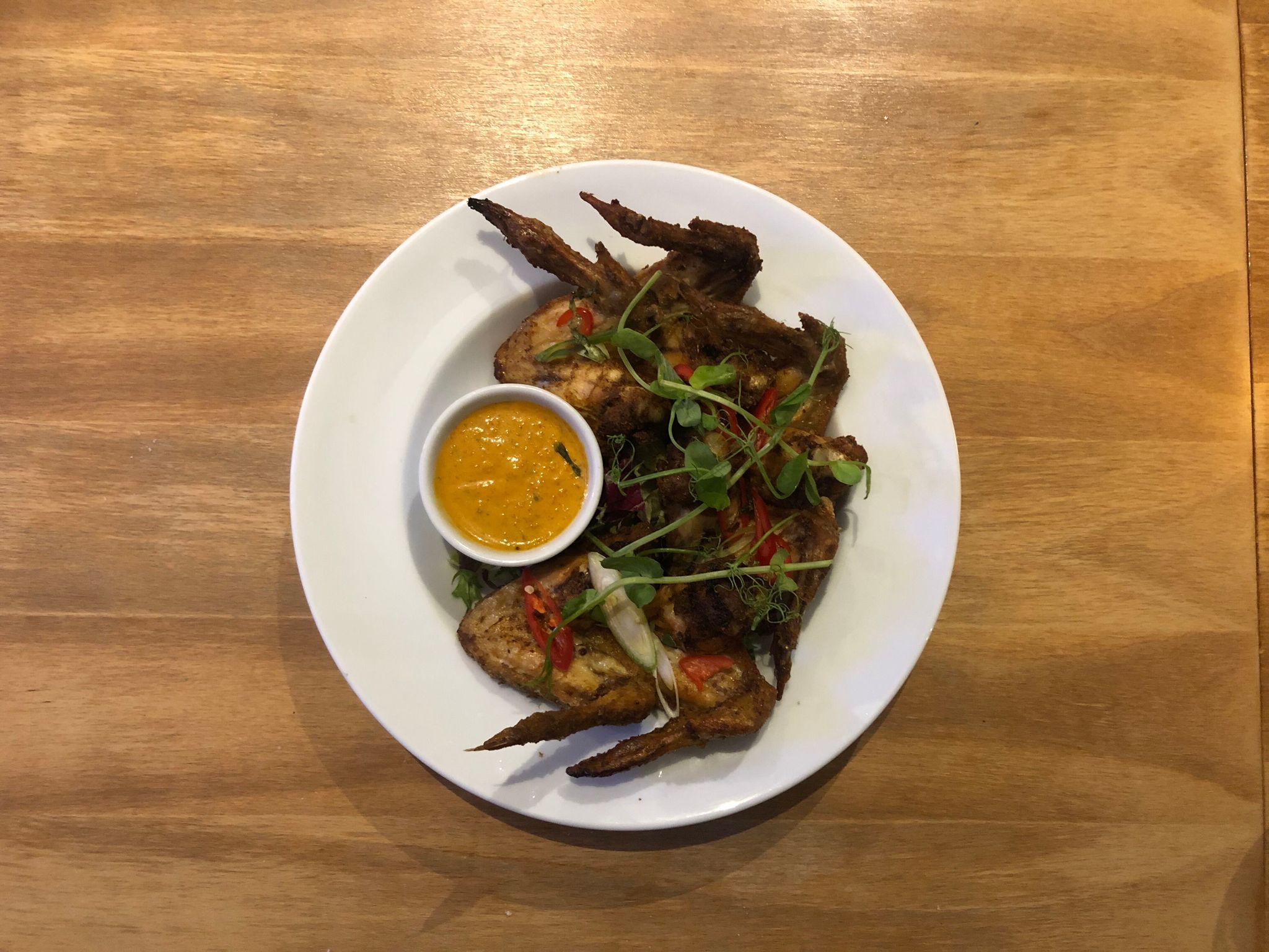 over head shot of the chicken wings doused in Lobos Hot Trini Sauce. Island Cusine at The Gather Inn