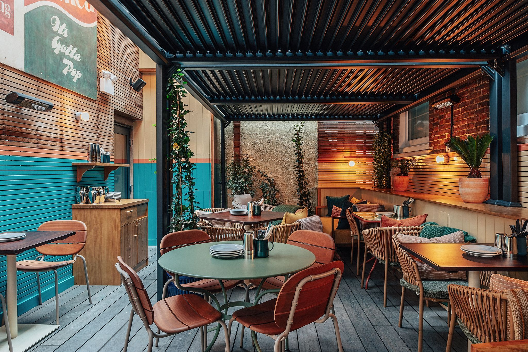 outdoor seating, wooden and almost orange chairs with different colours tables