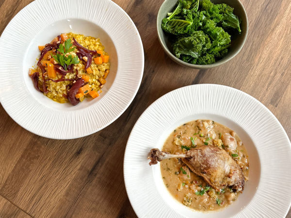 Risotto and meat dishes at The Chimney House with a side of kale.