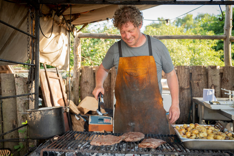 Restaurants Brighton - Woodfire Camping. Griff cooking over wood at their South Downs Campsite.