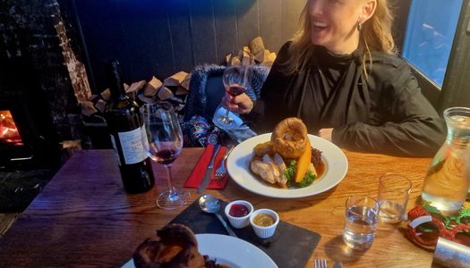 Jess friend enjoying her glass of red wine together with Sunday roast at The New Inn