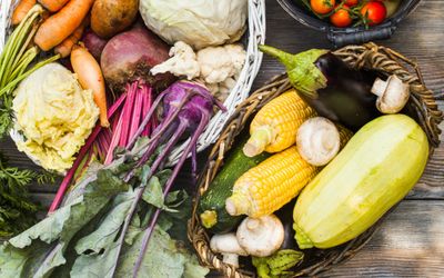 A variety of vegetables laid out on a wooden table
