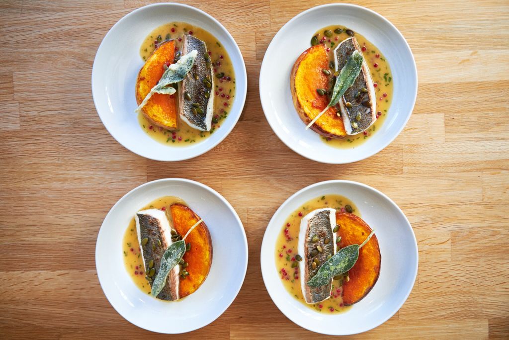 over head shot of the four plates of the main dish at the Little Fish Market restaurant in Hove. Duncan Ray and his team feature in the Michelin guide and have 3 AA Rosettes. All dishes pictured are fish dishes.