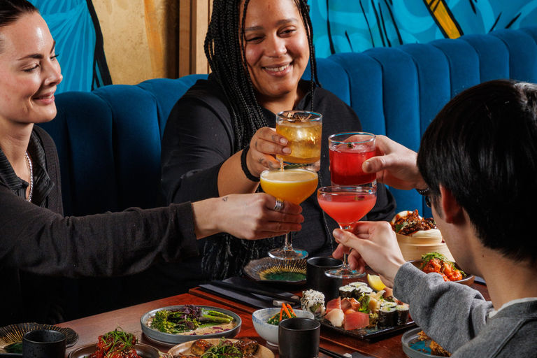 A group of people enjoying happy hour cocktails at food at Blossoms bar in Brighton. Restaurant deals and special offers