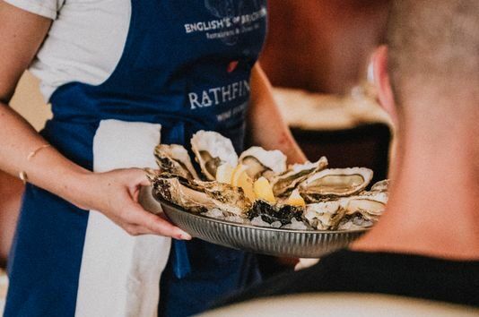 waiter holding plate with oysters