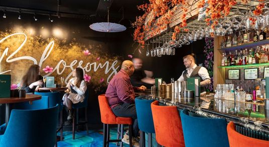 shot of the bar area at the Blossoms bar and restaurant in Brighton. People enjoying cocktails in beautifully decorated bar