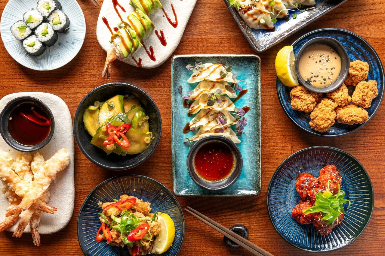 over head shot of the brown table laid out with small plates of Japanese cuisine at Blossoms Brighton