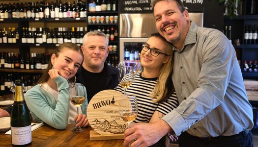 Fourth and Church - Best Wine List in Brighton and Hove in 2024 - BRAVO winners. Pictured, Paul Morgan and his team celebrating the win against a back drop of wine bottles at Fourth and Church on Church Road in Hove