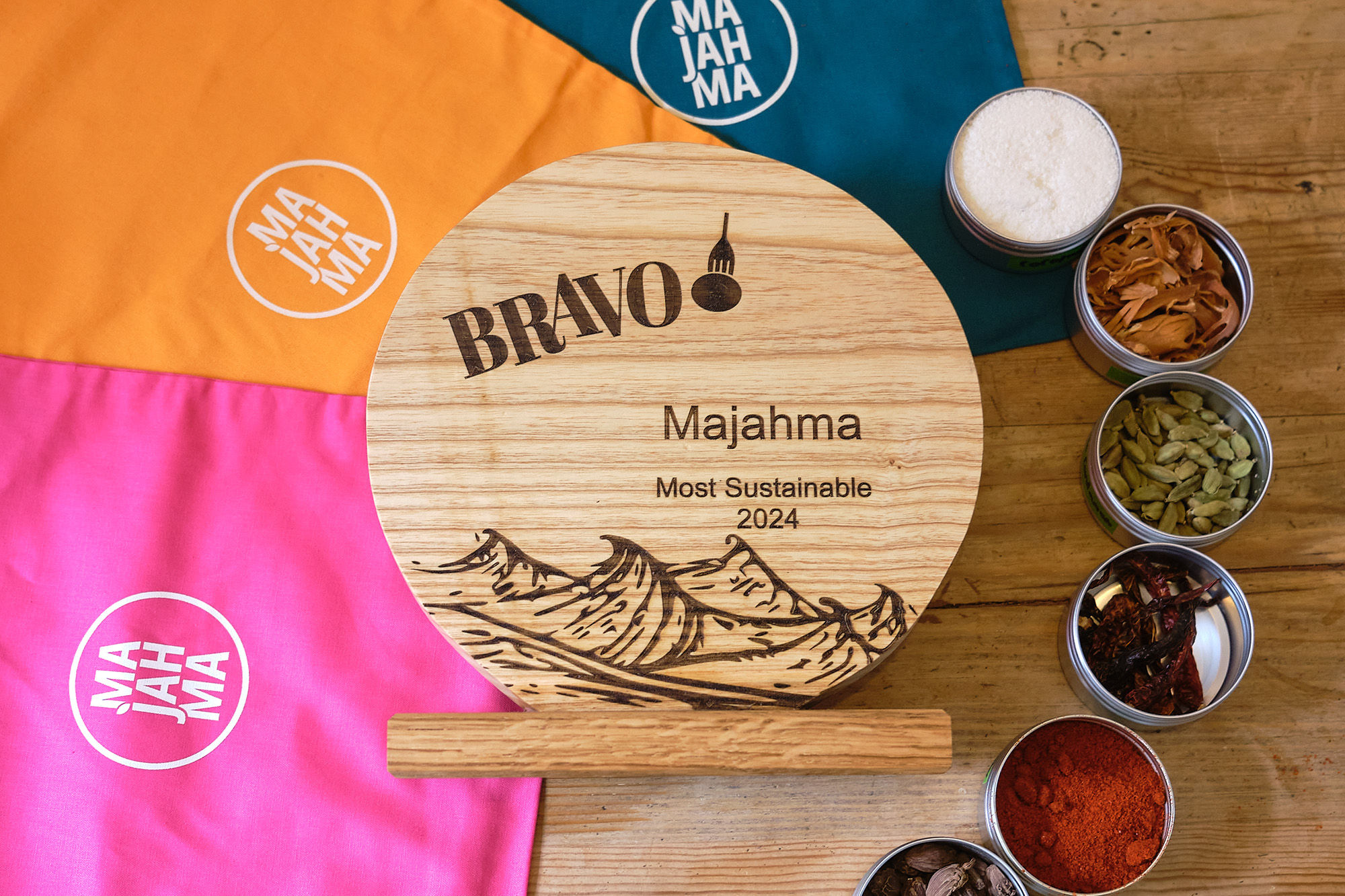 A run down of Brighton's top 20 most sustainable restaurants or businesses having a strong sustainable ethos. Pictured, the winner Majahma (Tiffin Delivery) and their trophy against a backdrop of their herbs and spices.