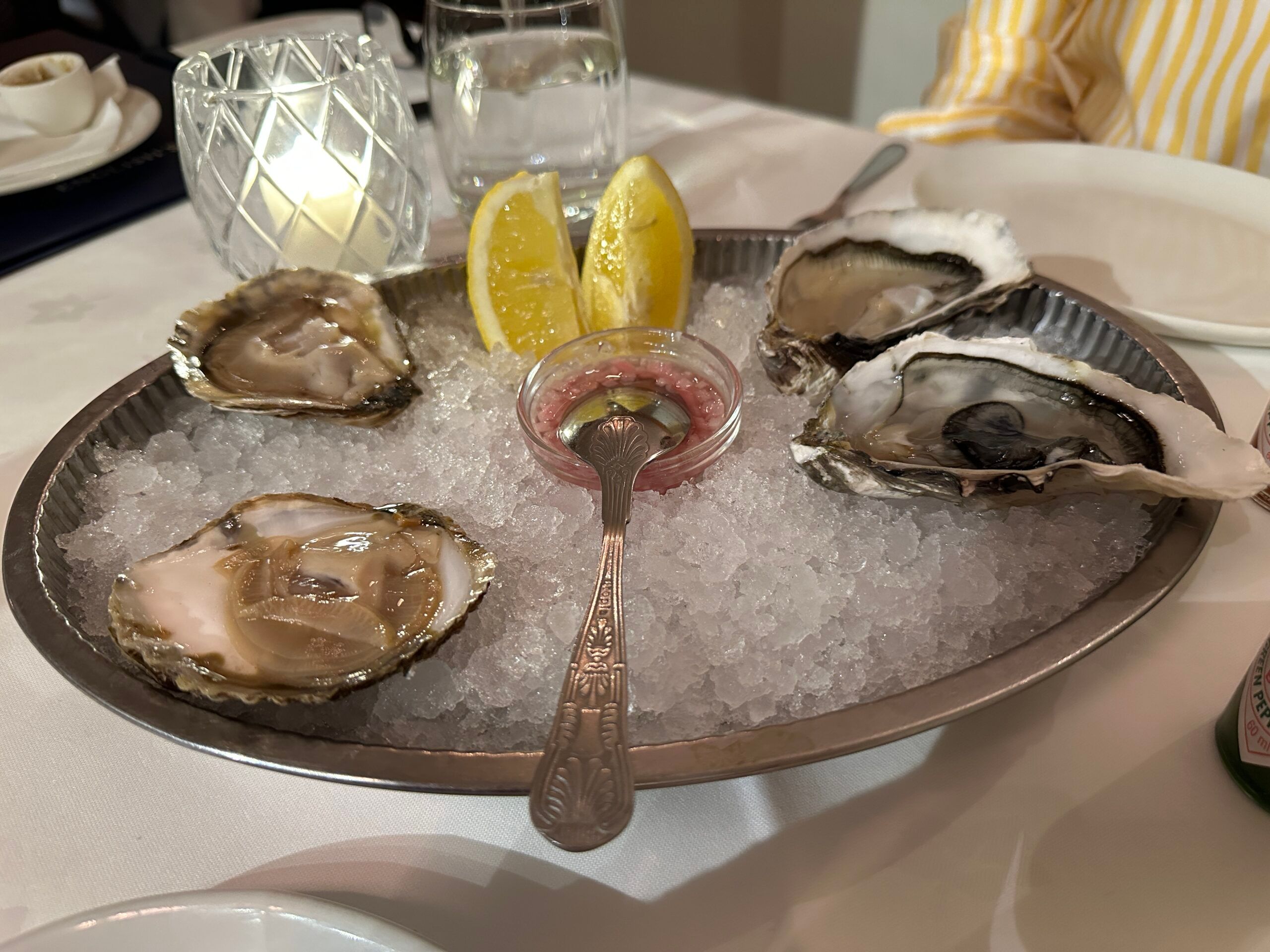 four oysters served on gray bowl filled with ice at English's of Brighton