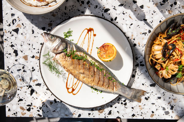 over heard shot of the fish served on the white plate with lemon at E Thirty Nine - E39. this picture headlines our guide to Mediterranean Restaurants in Brighton