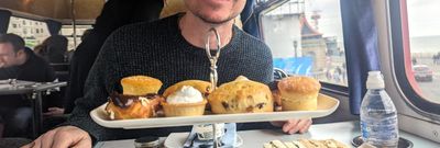 Hannah's husband in front of afternoon tea served on Brighton Regency Routemaster bus tour