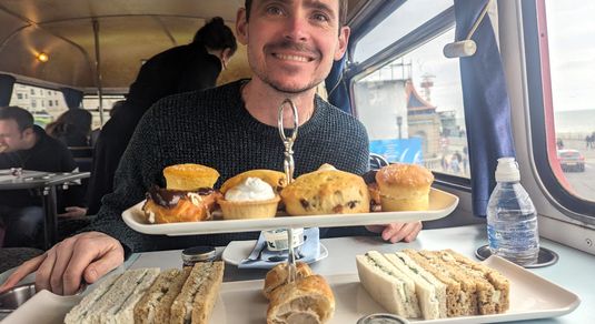 Hannah's husband in front of afternoon tea served on Brighton Regency Routemaster bus tour