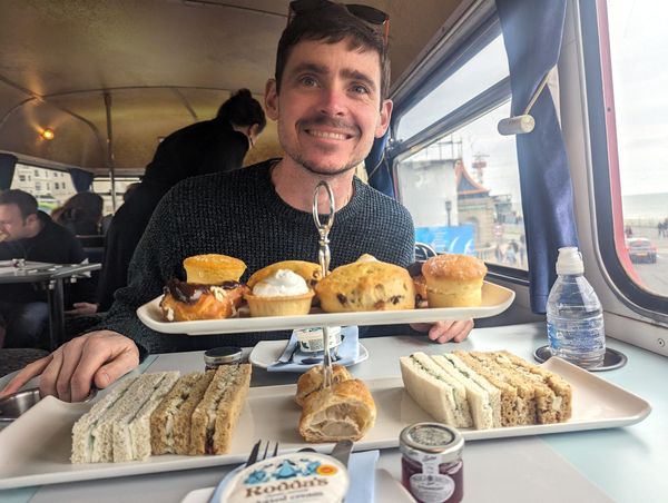 Hannah's husband in front of afternoon tea served on Brighton Regency Routemaster bus tour