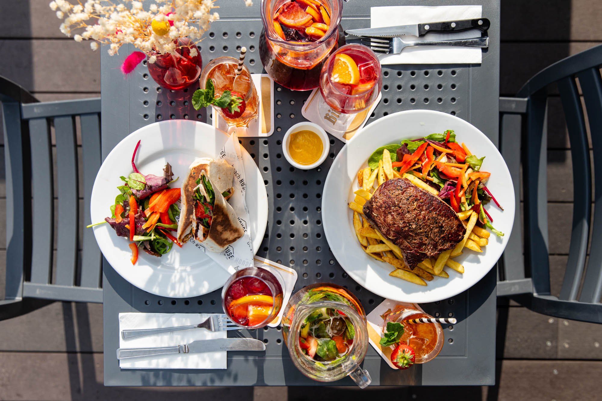 over head shot of the Beach House dishes and drinks served on the terrace table